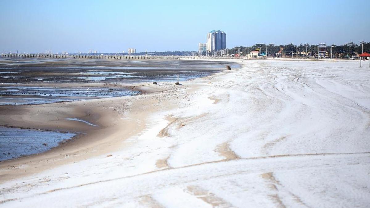 A thin layer of ice and snow dusts the beach in Biloxi on Jan. 18. The cold weather this winter in South Mississippi caused a spike in power bills.