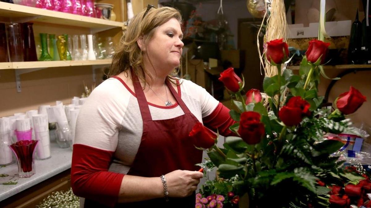 Kim Cospelich arranges a Valentine bouquet at Deen's Florist in Gulfport. Cospelich said she will be making arrangements on Valentine Day as last minute orders are made.