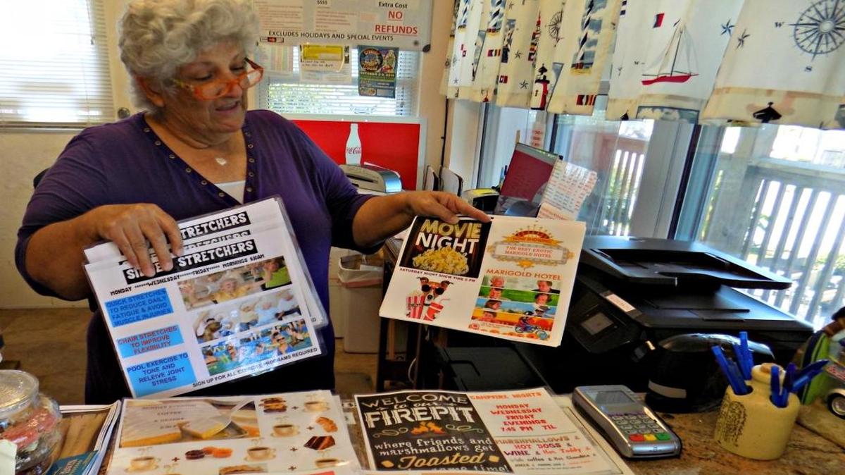 Susan Perkins shows list of activities offered to guests at Gulf Haven Campground on the beach in Gulfport. After Cruisin' The Coast the first week in October, the RV park will be home to snowbirds for the winter.