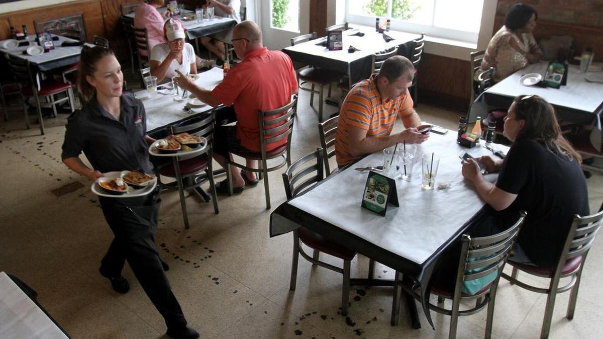 Kaytlin McCormick of Ocean Springs brings plates to a table at Half Shell Oyster House restaurant in Biloxi on Monday, Aug. 8, 2016.