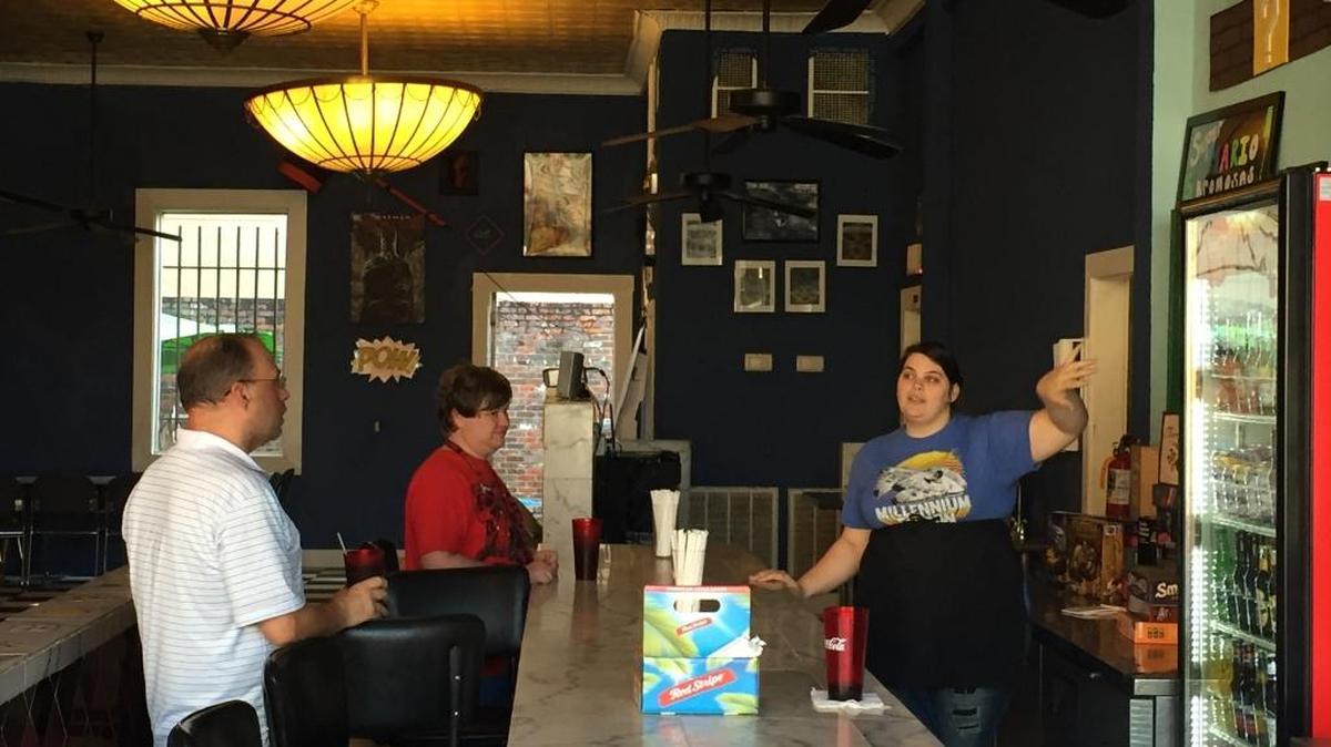 Canonblue Lalley, right, co-owner and chef at the Wayward Kraken, points out beverages to customers at the Wayward Kraken in Biloxi on Tuesday, Feb. 7, 2017.