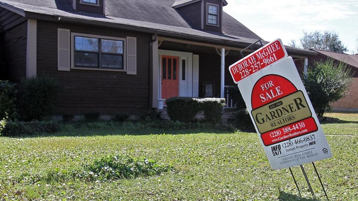 A sign proclaims a house for sale in Gulfport on Tuesday, Feb. 26, 2013. More homes were sold and listed on the Coast in October and buyers and sellers watch the possible increase in interest rates.