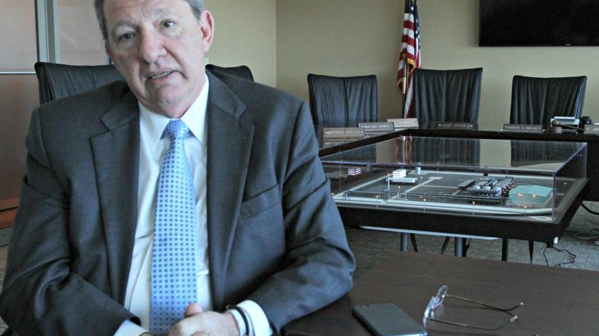 Bruce Hall, president and COO of SeaOne, sits in front of a model of the production plant the company plans for the Port of Gulfport’s West Pier. The port commission approved a 40-year lease Thursday with SeaOne for acreage on the renovated and expanded West Pier.