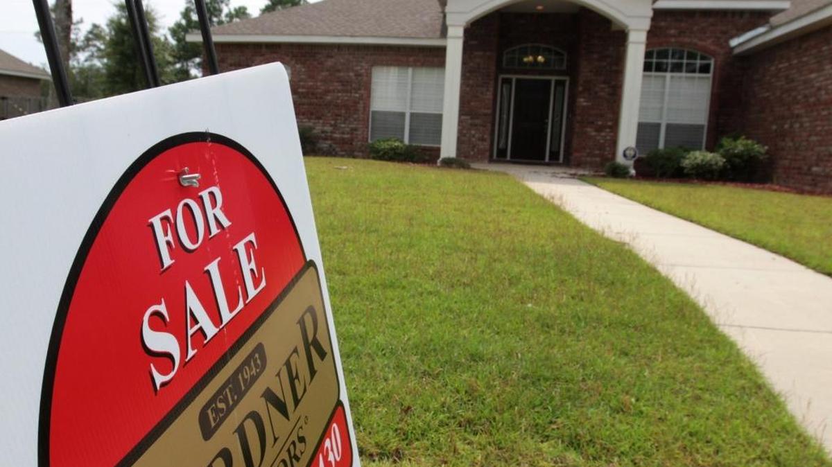 A “for sale” sign is posted at a property in D’Iberville. Home sales were brisk in May and the average sales price of a home in South Mississippi was close to $154,000.