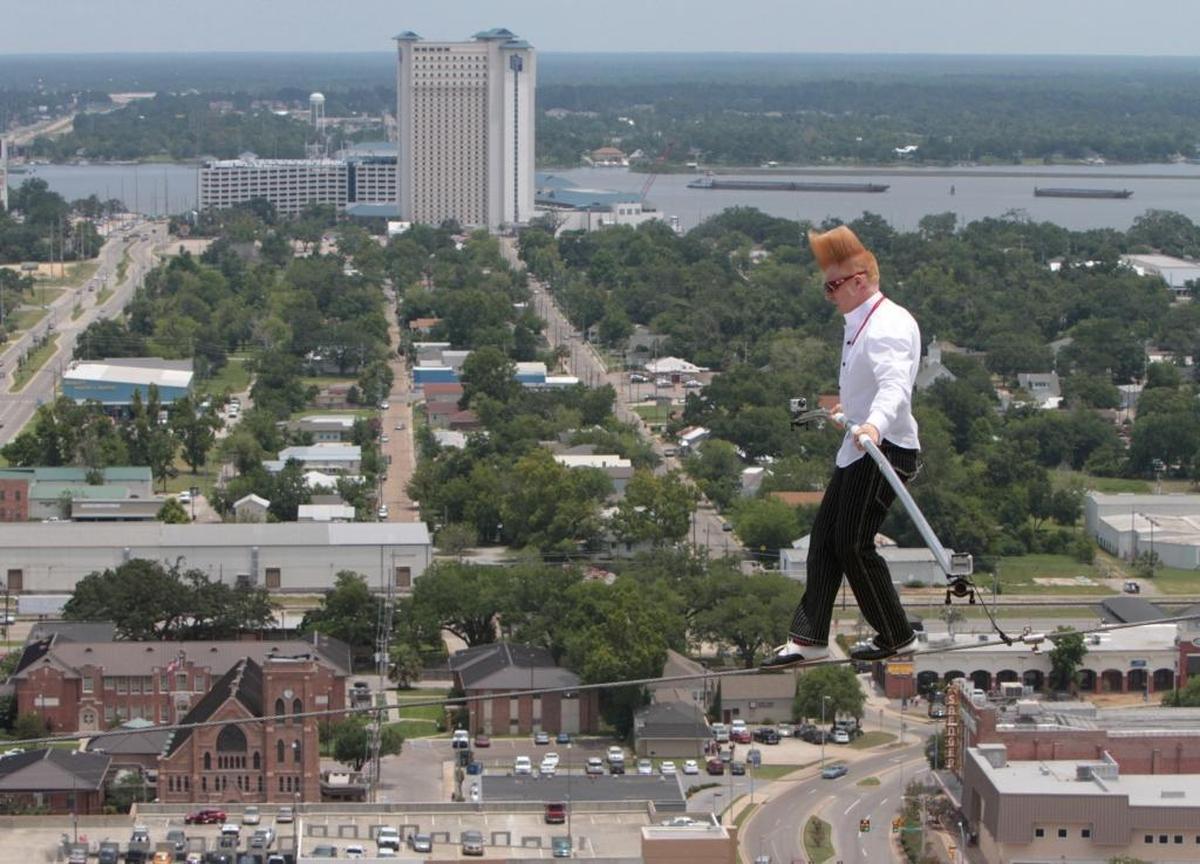 Comic daredevil Bello Nock walks a high wire strung across the front of the Beau Rivage Resort & Casino in Biloxi on June 21, 2012, while thousands of people watch from below. A year later he hung by his foot from a helicopter flying low over the casino, where he performed in shows during the summer.