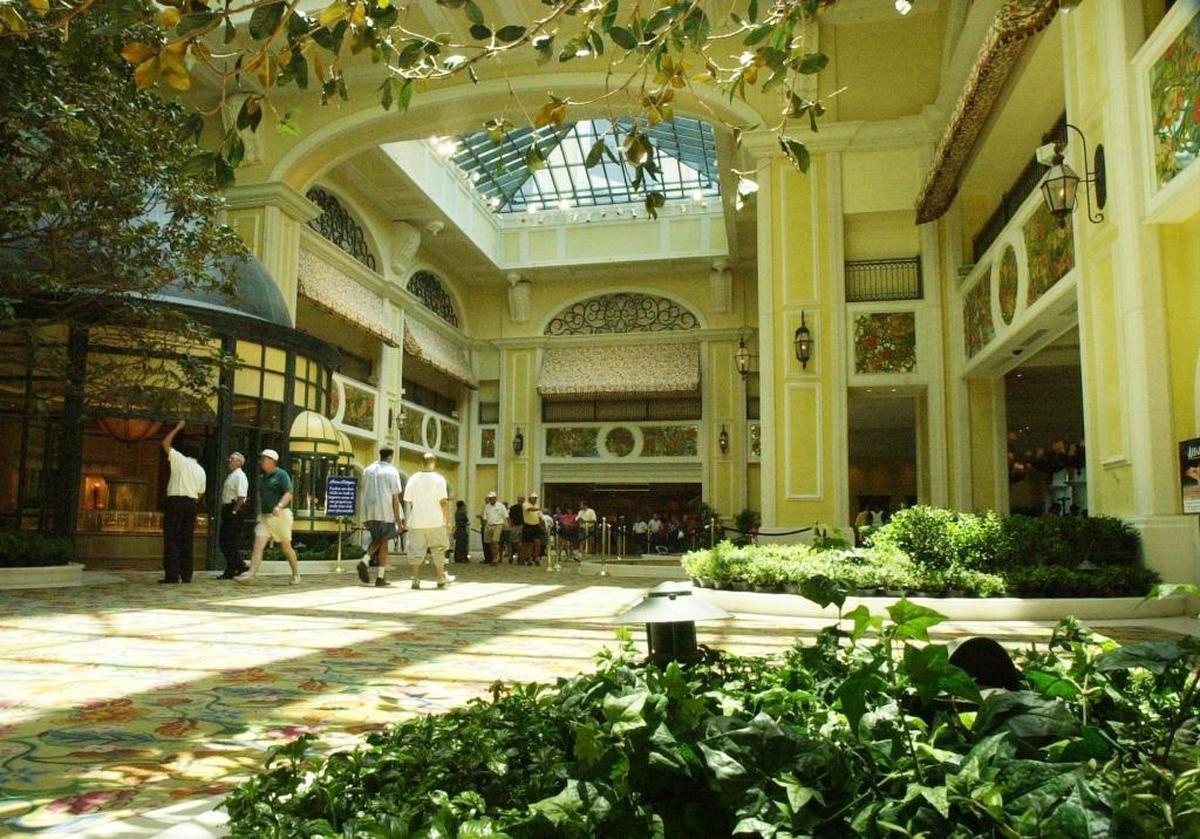 Patrons of Beau Rivage walk past the atrium where large Magnolia trees were once planted. Despite efforts to save the trees, the casino resort has removed the magnolia trees with plans to replace them with another type of tree.