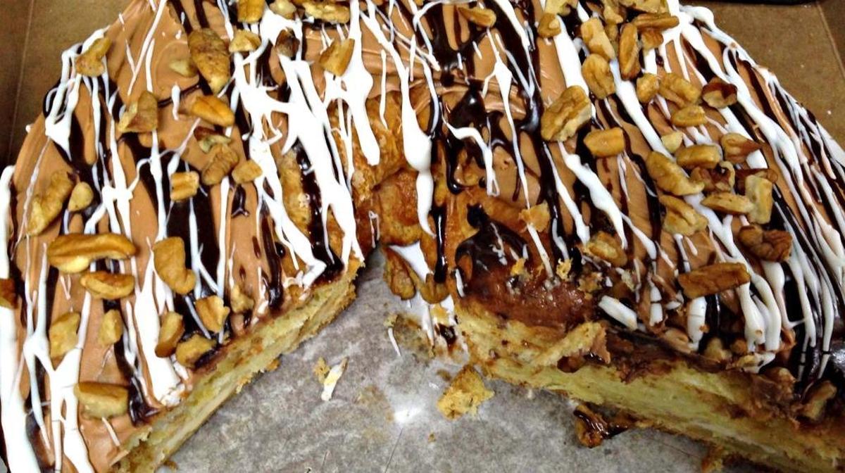 A slice or two of Millionaire King Cake from the Palace Café & Bakery is filled with pecans, caramel, chocolate and other goodness.