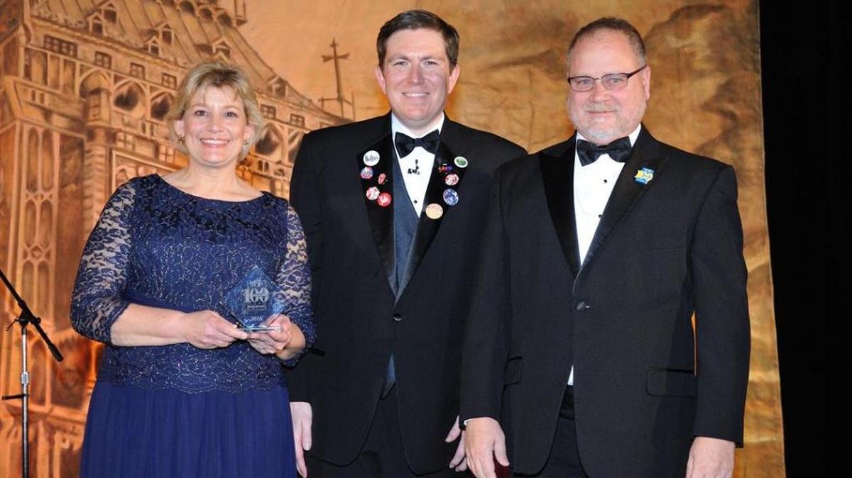Christine Ladner, left, and John Ladner, right, owners of Breath’s Boats & Motors in Bay St. Louis, are honored as one of the Top 100 independent boat dealers in North America by Boating Industry editor Jonathan Sweet.