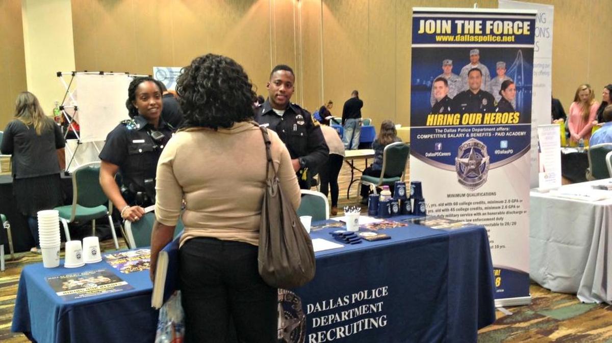 Members of the Dallas Police speak with a job applicant at a job fair in Biloxi in 2016. Unemployment Eliminators will host a job fair at the Coast Convention Center in Biloxi on July 18.