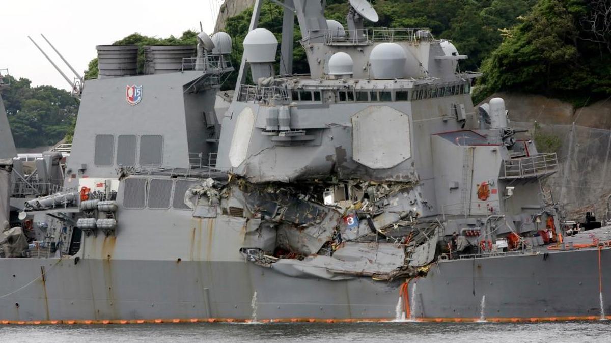 In this June 18, 2017, file photo, damaged USS Fitzgerald is docked at the U.S. Naval base in Yokosuka, southwest of Tokyo, after colliding with Philippine-flagged container ship ACX Crystal off Japan. Seven sailors died in the collision. The ship will be brought to Ingalls Shipbuilding in Pascagoula for repairs.