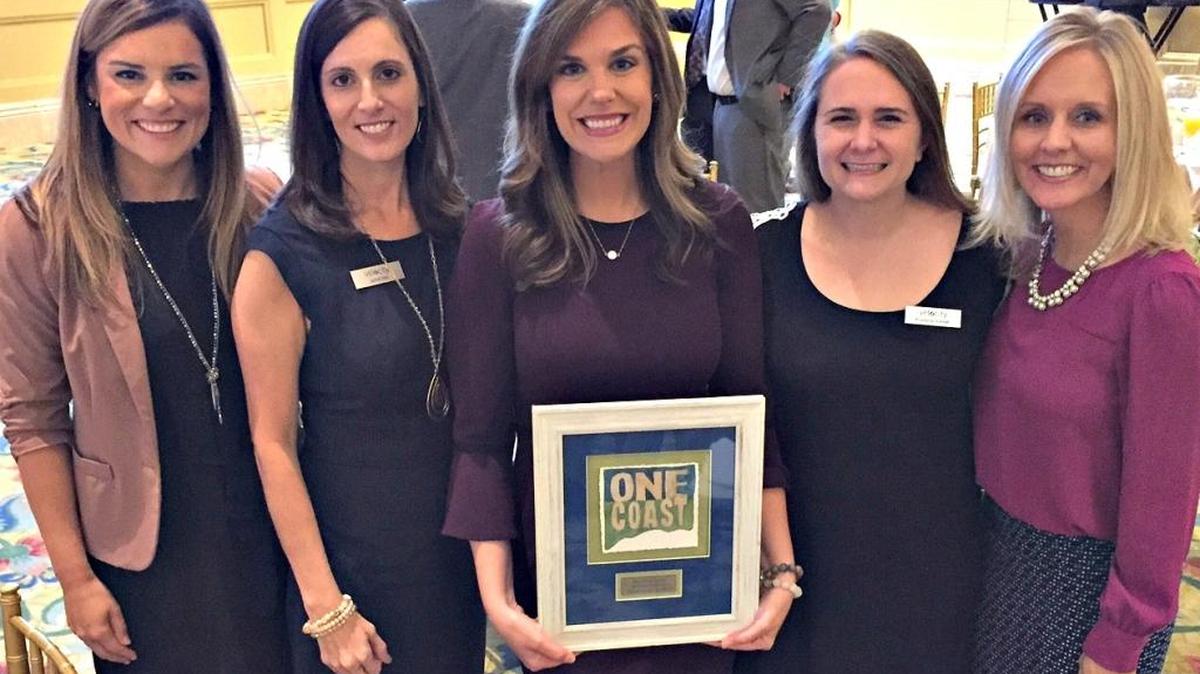 Brittany Ridgway, center, marketing and communications manager at The Sun Herald and Velocity, is congratulated by co-workers Wednesday after winning the One Coast Top 10 Under 40 award. From left are Chynna Hyde, Jamie Dick, Ridgway, Krystyna Schmitt and Sun Herald Publisher Shannon Wall, who was nominated as a top Community Leader.