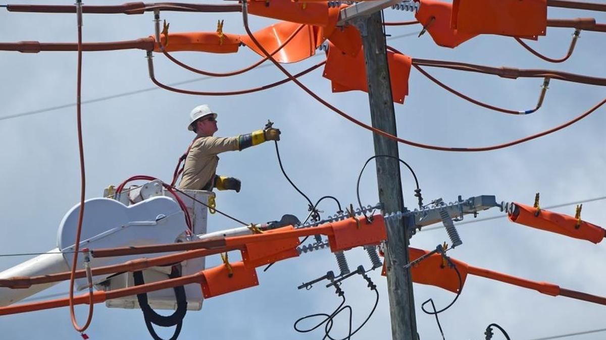 A Mississippi Power lineman works in Gulfport. Rates are decreasing by $4.14 a month for the average Mississippi Power customer due to lower energy costs.
