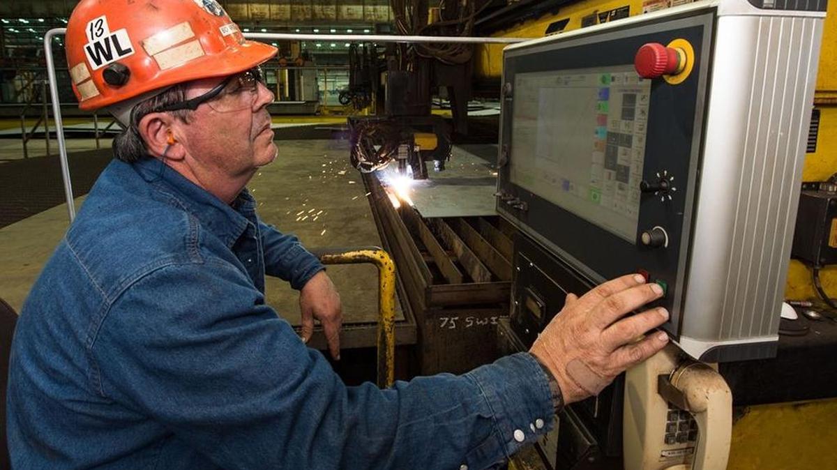 Paul Bosarge, a steel fabrication burner at Ingalls Shipbuilding in Pascagoula, presses the button to start fabrication of the destroyer Lenah H. Sutcliffe Higbee (DDG 123). Bosarge has worked at Ingalls for 39 years.
