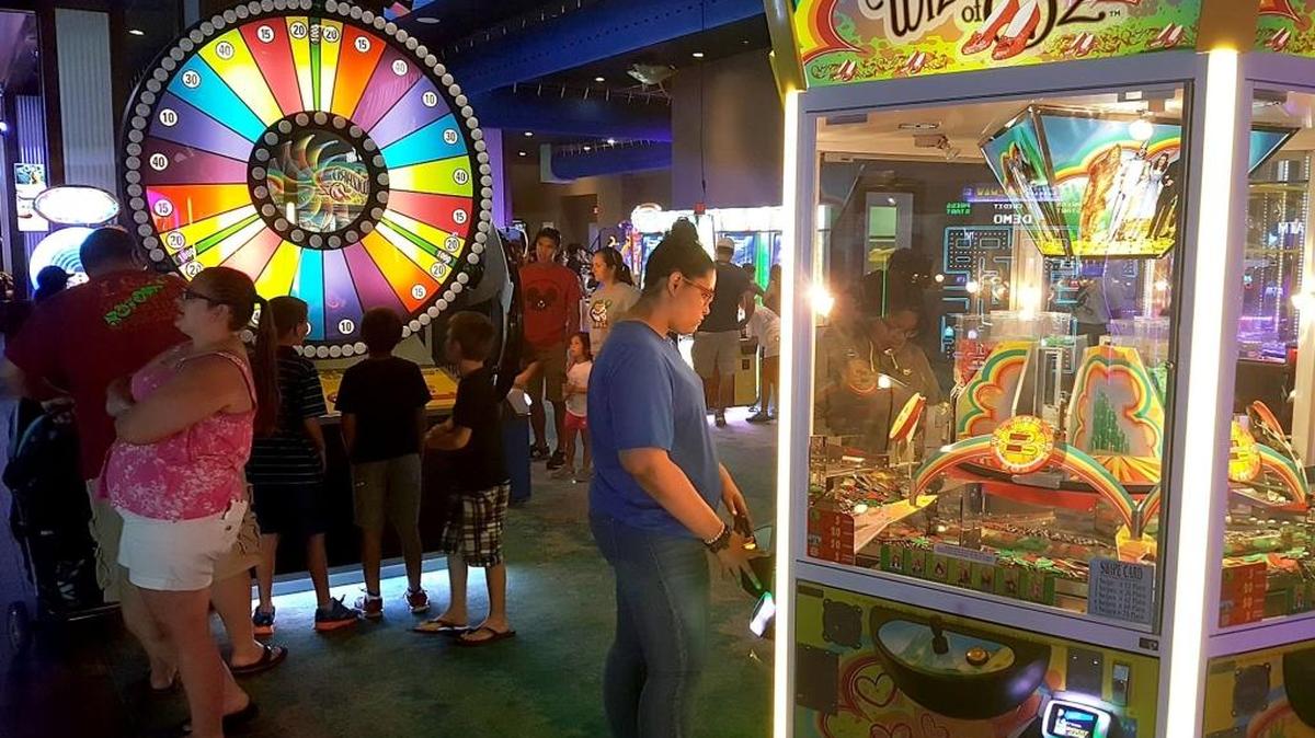 People gather round games at Margaritaville Resort Biloxi, which will reopen Sunday, Oct. 15, a week after crews repair much of the damage caused by Hurricane Nate on Oct. 7 and 8.