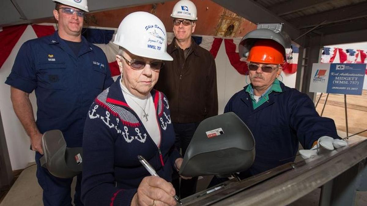Ship Sponsor Jazania O’Neal writes her initials on a steel plate that will be welded inside Midgett (WMSL 757), the National Security Cutter named in honor of her grandfather, John Allen Midgett. Pictured with O’Neal are Capt. Christopher Webb, left, commanding officer, U.S. Coast Guard Project Resident Office Gulf Coast; Brian Cuccias, Ingalls Shipbuilding president, and Jack Beard, a structural welder at Ingalls.
