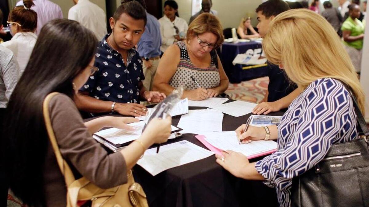 In this July 19, 2016, file photo, people fill out job applications at a job fair in Miami Lakes, Fla. Unemployment rose across the three Coast counties in December.