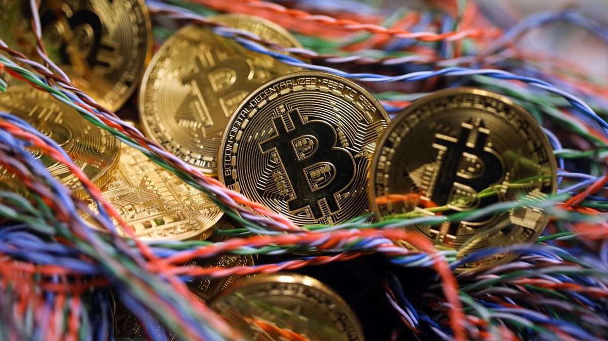 Bitcoins sit among twisted copper wiring inside a communications room at an office in this arranged photograph in London in September.