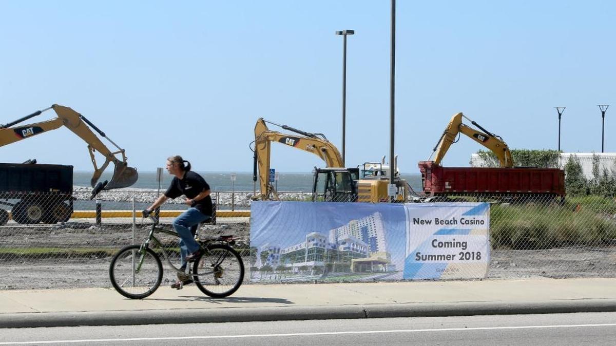 A cyclist rides past new construction for the Island View Beach Casino south of U.S. 90 in Gulfport, Friday, May 19, 2017.