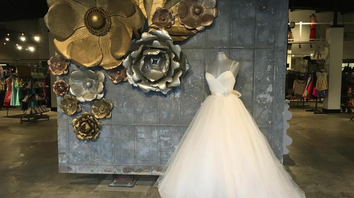 Co-owner Chavus Holland used old industrial doors for the backdrop of this display at the entrance of Bridal and Formal Boutique/House of Tux in Gulfport.