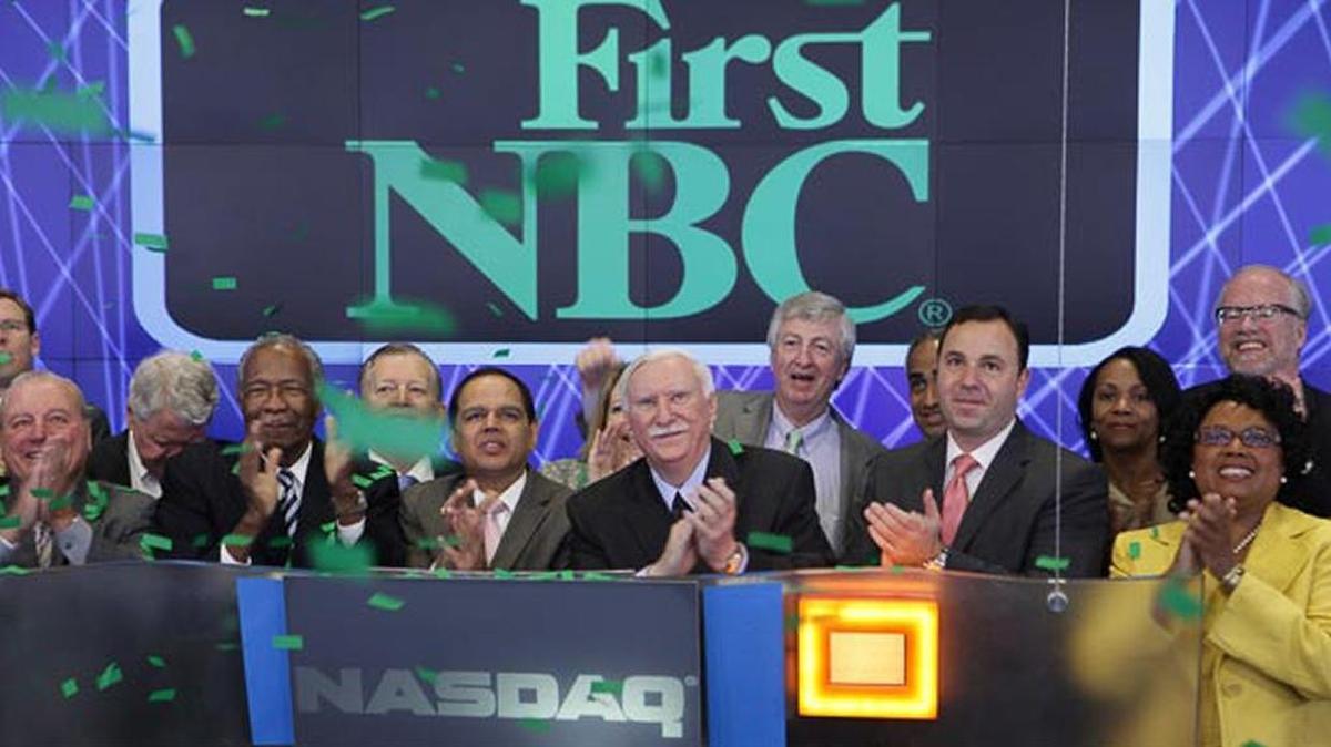 First NBC Bank Holding Company and then-CEO Ashton Ryan Jr., center, rang The NASDAQ Stock Market Opening Bell in celebration of their IPO in May 2013. In April, federal and state regulators seized the beleaguered institution, ordering it closed and initiating a $1 billion cleanup, the costliest failure of an American bank since 2010.