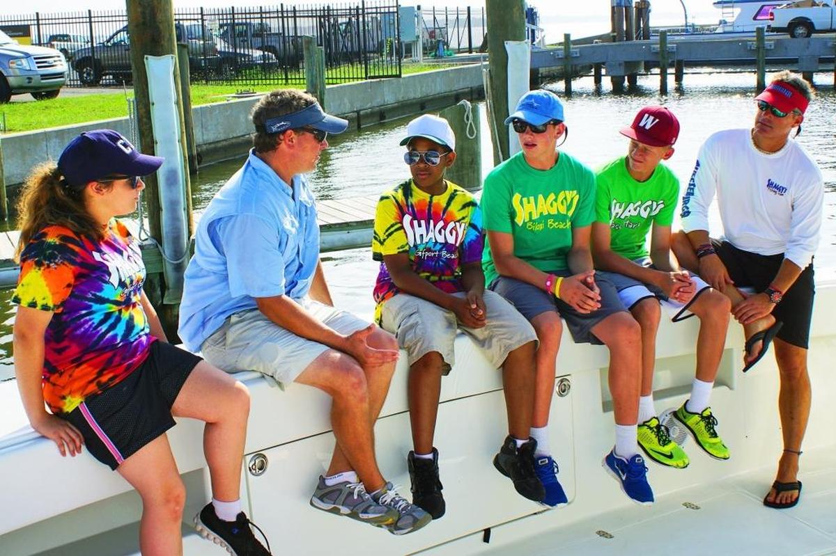 Shaggy’s owners Rimmer Covington and Ron Ladner talk to children who participated in the Shaggy’s Kids Foundation’s Kids Catch.