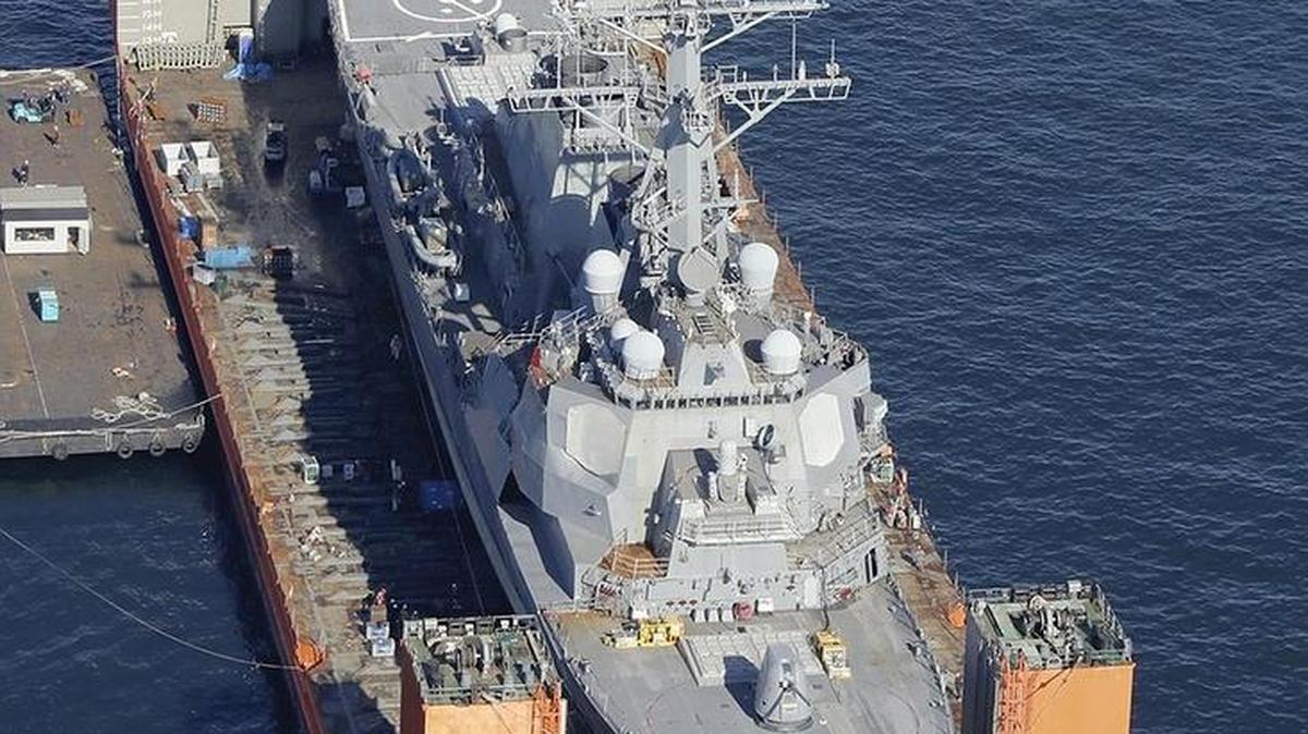 The USS Fitzgerald, seen on a U.S. lift transport vessel off Yokosuka, Japan, on Saturday, is on its way to Ingalls Shipbuilding in Pascagoula for repairs and restoration.