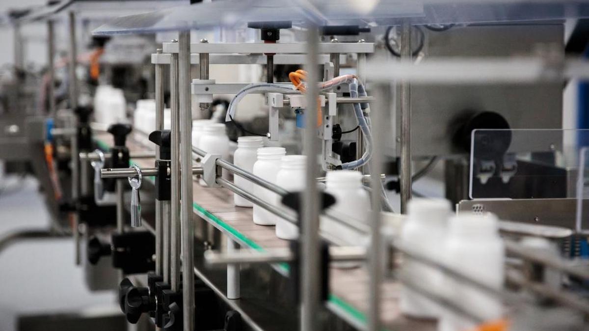 Containers move along a conveyor on the packaging line for metformin pills at a Laurus Labs pharmaceutical plant in Visakhapatnam, India, on Nov. 15, 2017.