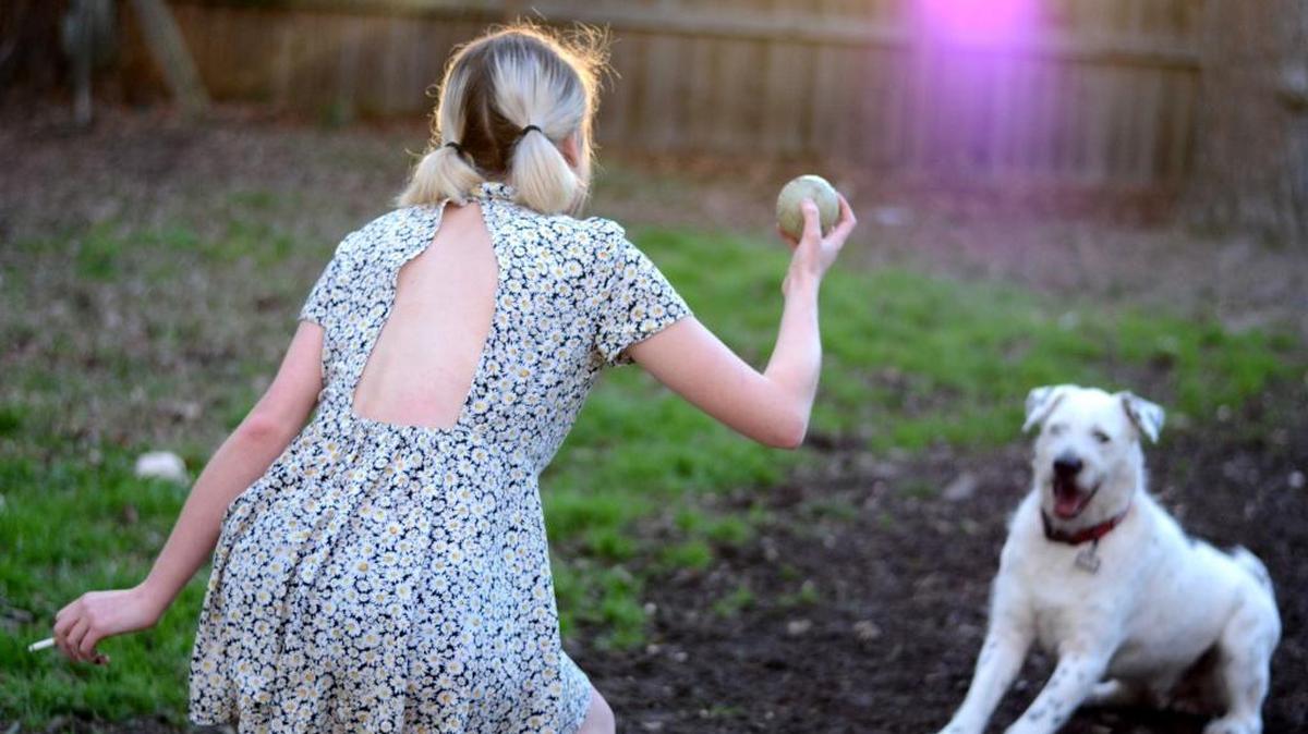 Alissa plays fetch with her dog behind Spice World in March.