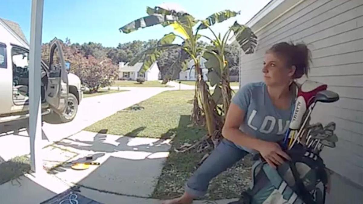 A frame grab from a security camera shows a woman taking a set of golf clubs from the porch of a Biloxi house on Monday, May 8, 2017. The surveillance video was the most popular of the year on sunherald.com.