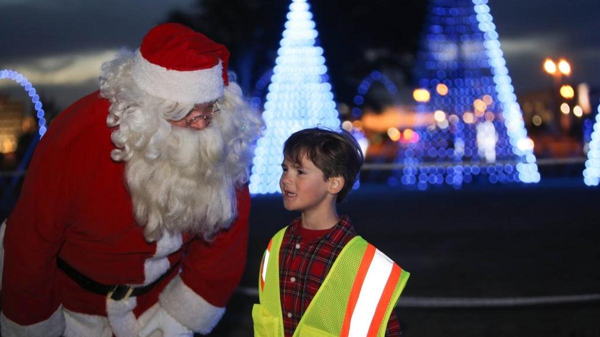 Asher Griffin, 6, of Gulfport, speaks to Santa Claus after turning the lights on at the holiday light show in Jones Park on Nov. 22. The lights are on nightly from 5 to 9 p.m. through Jan. 1.
