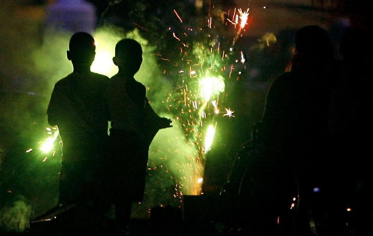 Children play with sparklers on the beach in Gulfport at the July 4 fireworks.