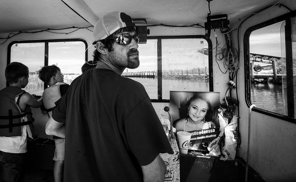 Bruce Sellier, center, steers a boat along Bayou Caddy on Sunday, June 25, 2017, to the place where the boat Vanessa Mauffray, photographed right, was in was it was broadsided, causing her death one year prior. Family and friends gathered and boated to the spot to place a new wreath at the location, along with flowers and to release balloons. Photographer’s comments: This was a somber event to cover. I feel like the composition says a lot about what it was like, as a bystander, to be with the family as they paid their respects on the one-year anniversary of Vanessa Mauffray’s death.