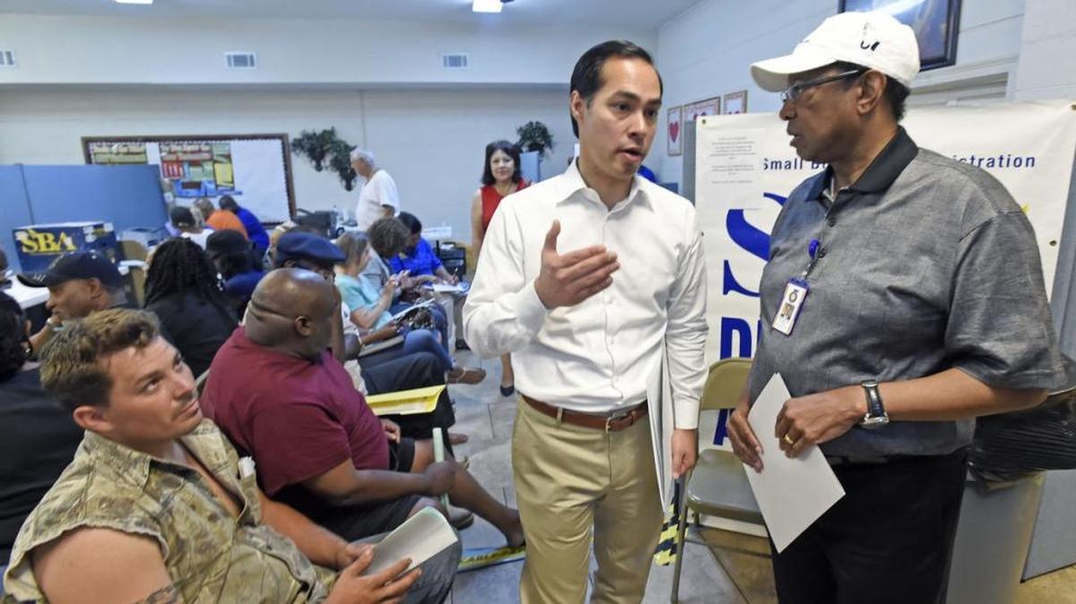 U.S. Department of Housing and Urban Development Secretary Julian Castro chats with East Baton Rouge Mayor-President Kip Holden, right, at the Disaster Recovery Center in Baton Rouge.