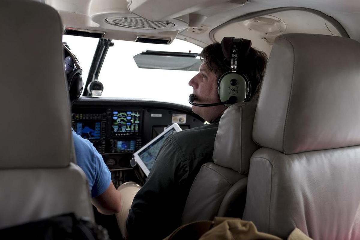 Scott Eustis of the Gulf Restoration Network views the Gulf of Mexico during a flight out of New Orleans on July 21, 2018.