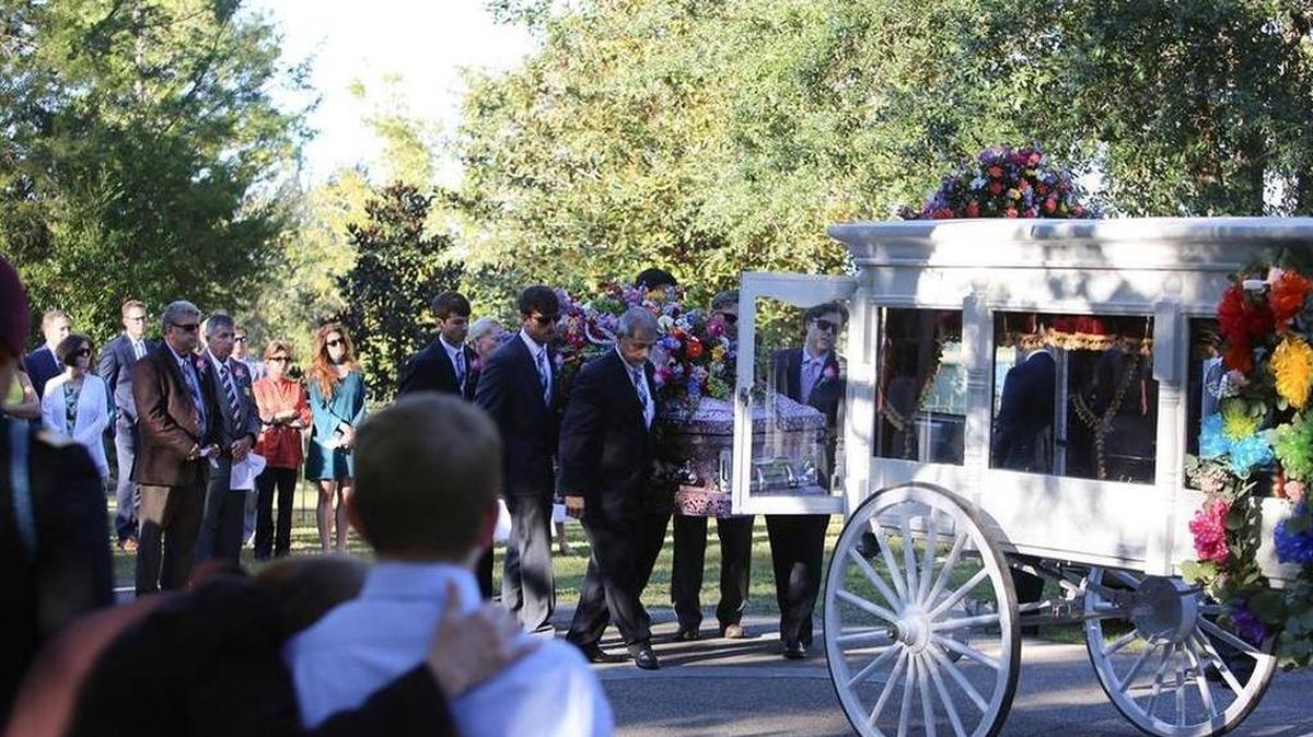 Josh Myers, far right, along with family of 7-year-old Sophia Myers, place her casket into a carriage Thursday, Oct. 26, 2017.
