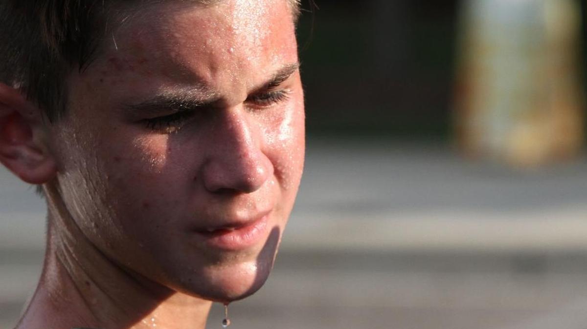 Sweat drips from Patrick Brown’s face as he practices with the Long Beach High School band before performing at the Gulf Coast Invitational Marching Festival at Biloxi High School on Saturday.