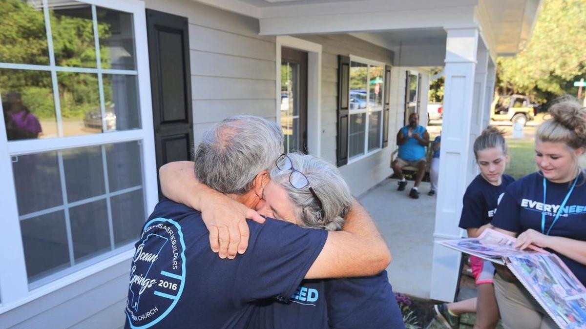 Nancy Watling hugs Bart Tucker of Fuller Center Disaster ReBuilders during the dedication on Friday, Oct. 21, 2016, of a new house built in Jackson Couty for her by the disaster-relief group.