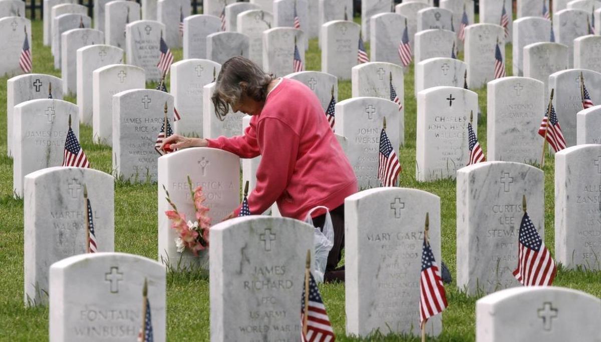 Despite the weather, Shirley Paxson took time to visit the grave of her husband, Frederick Paxson, for Memorial Day at Biloxi National Cemetery. Photographer’s comment: This photo is from that photographer’s adage of go early, stay late. The good photos usually do not happen at the assigned time. I have always tried to get to an assignment such as this early and stay after the assigned event. This photo is about 20-40 minutes after the commemoration of Memorial Day. I think a solitary moment can say more than most speeches.