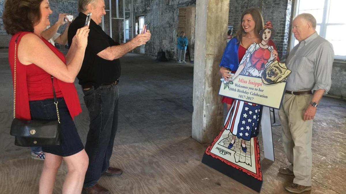 Hancock County Chamber of Commerce director Tish Williams and David Thornton of Transmedia snap photos of Jaimee Dorris and Jim Miller of the Gulfport Historical Society at Centennial Park in Gulfport on Saturday, March 18, 2017.