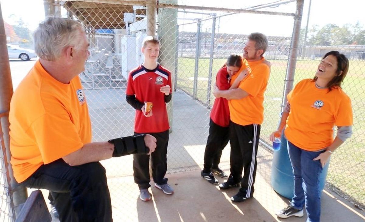 Mississippi Coast Special Needs Soccer Association president Allen Pilcher, left, of D'Iberville, meets with board members Kenny and Patti Wilson of Woolmarket after games at the Bobby Eleutarius Sports Complex in D'Iberville on Saturday, Dec. 2, 2017. Two of the Wilson's children, Jake and Jordan, both 17, play in the league, and their other two children volunteer.