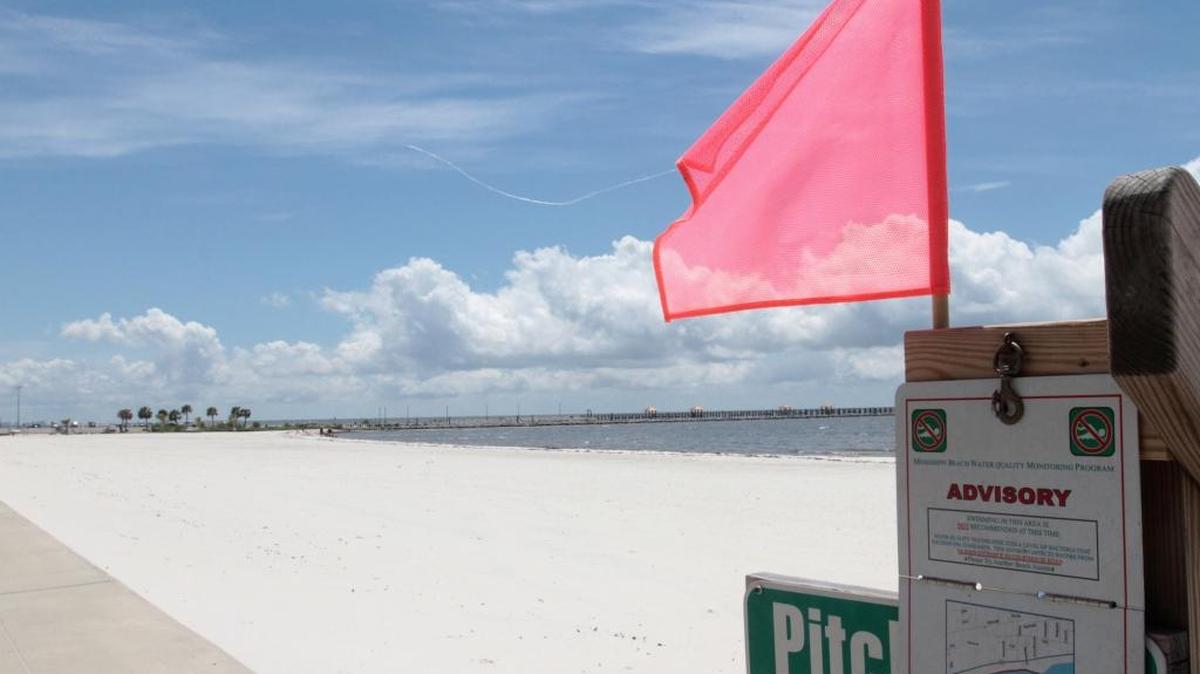 A swimming advisory sign on the beach west of Courthouse Road in Gulfport warns visitors about high bacteria levels in the water in June 2014.