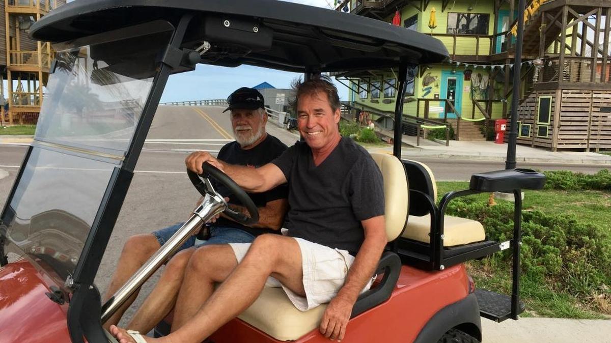 Edmond Meyer, right, and Wild Bill, enjoy riding a golf cart in Old Town Bay St. Louis. Beginning  May 31, carts will be legal on some streets in Ocean Springs.