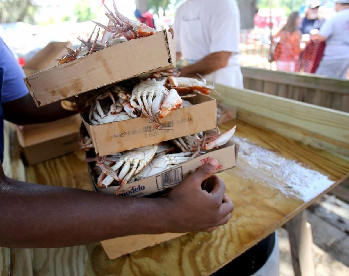 Trays of freshly boiled crabs are moved to the front for sale after being sorted at Our Lady of the Gulf Church’s Crab Festival in Bay St. Louis, a Fourth of July weekend tradition..