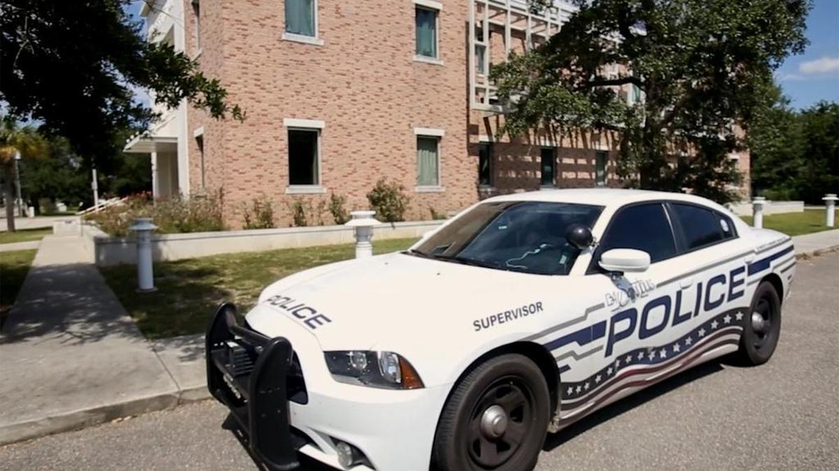 A Bay St. Louis Police Department cruiser is parked in front of the department's temporary home at the Fire Department.