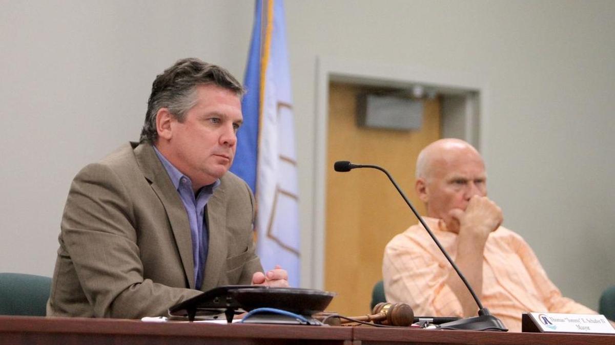 Diamondhead Mayor Tommy Schafer IV and Ward 3 Councilman Thomas Sislow listen to presentation by Samantha Atkinson during city council meeting, Monday.