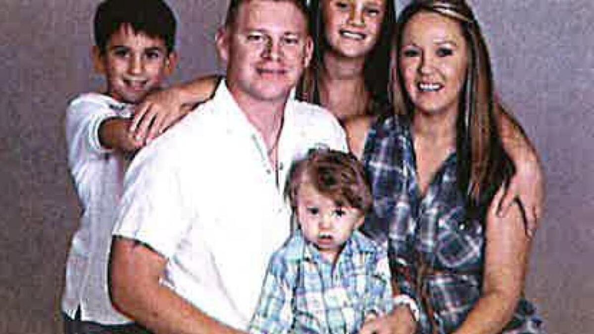 Hancock County Deputy Zack Bass with his wife Christy and their children.