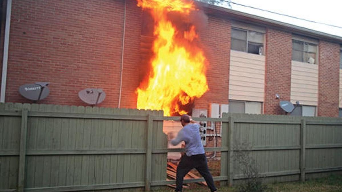 A Thursday afternoon fire burns in a Bay St. Louis apartment building as an off duty New Orleans fire fighter helps to stop the blaze.