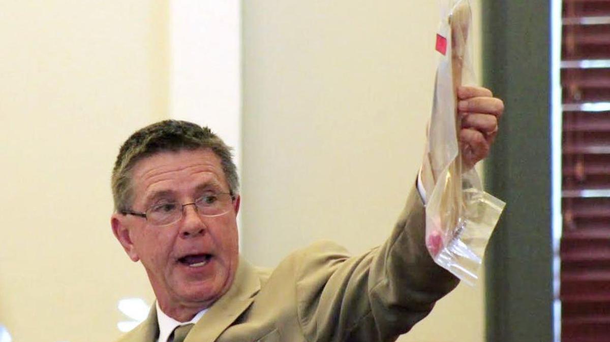 Hancock County sheriff’s Capt. John Luther on Thursday shows the jury a piece of evidence recovered from Leslie Danielle DeWitt’s home.