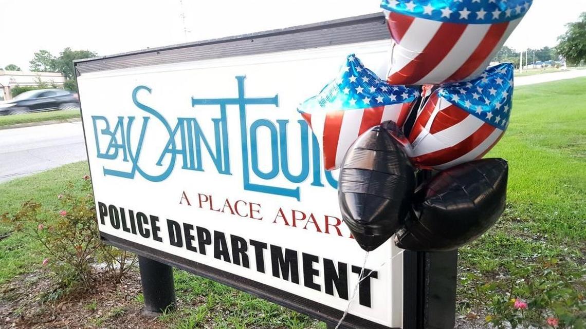 Balloons are attached to the Bay St. Louis Police Department sign on U.S. 90 in honor of Chief Mike De Nardo, shortly after he killed himself outside the department. Both De Nardo and his wife, Patricia, a former part-time officer, are connected to a payroll fraud investigation into the department.