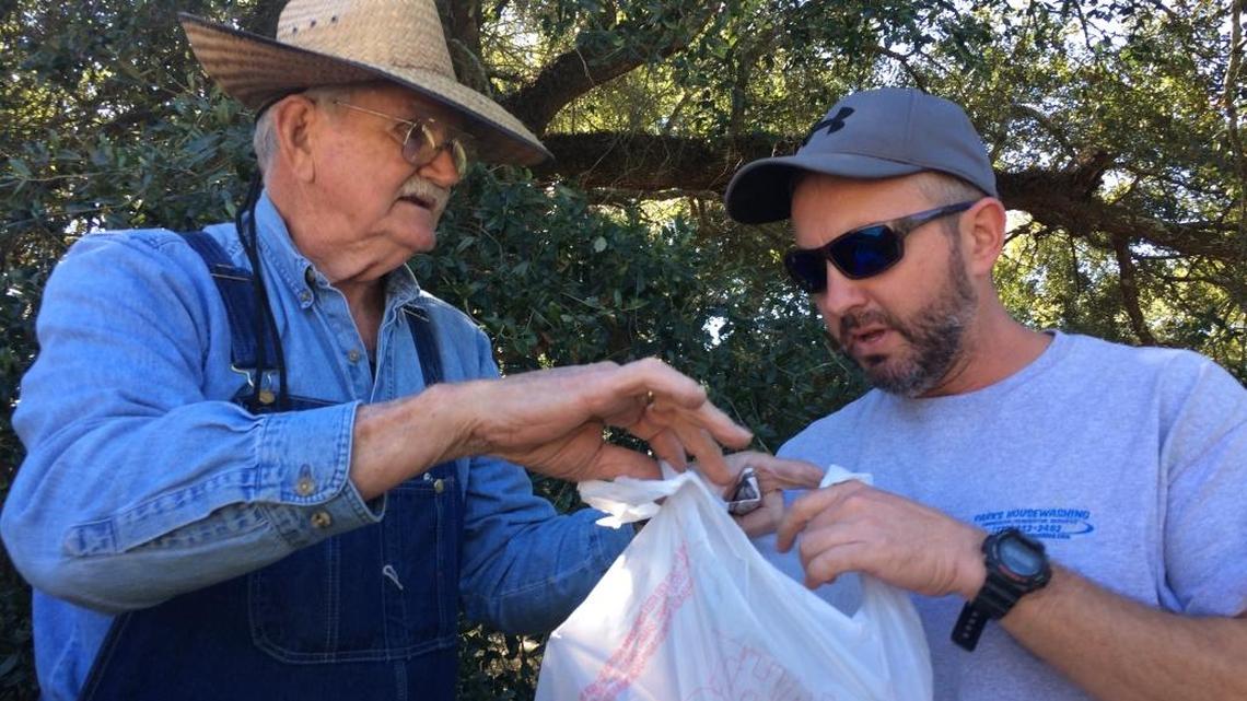 Bobby Seymour of Gulfport, right, stopped to buy kindling Monday from Kenneth Smith after seeing a Facebook post that went viral. In the post, a Gulfport resident talked about how friendly Smith is and how hard he works, even though he recently lost his wife to cancer.
